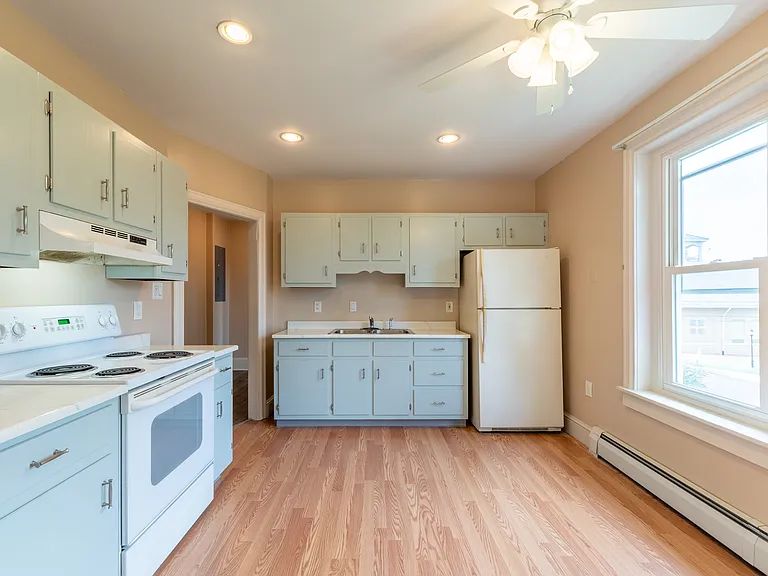 Kitchen located between Living Room and Bathroom