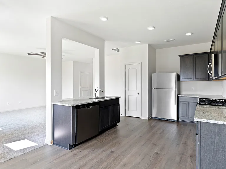 The kitchen has sprawling granite countertops.