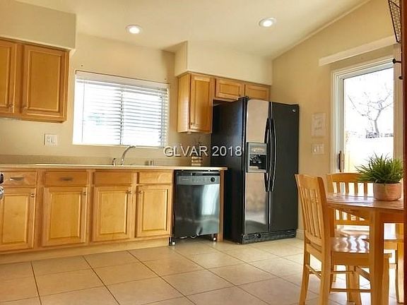 KITCHEN WITH SLIDING GLASS DOORS TO BACKYARD PATIO.