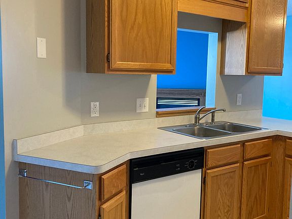 Kitchen sink view opens up to living room and deck
