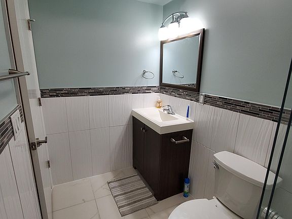 BRAND NEW Bathroom with standing shower. Hot water is included in the rent.