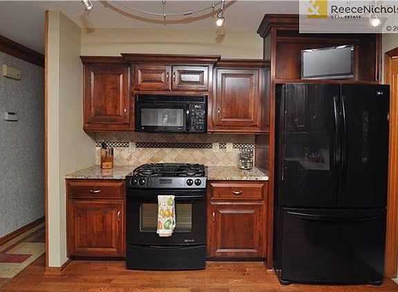 Gorgeous granite and tile backsplash; wired for cable; hardwood floors; and some pull-out shelving