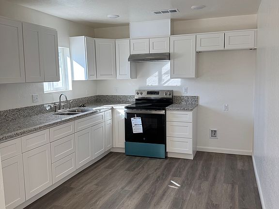 Beautiful kitchen with grinding cabinet tops brand new stove.