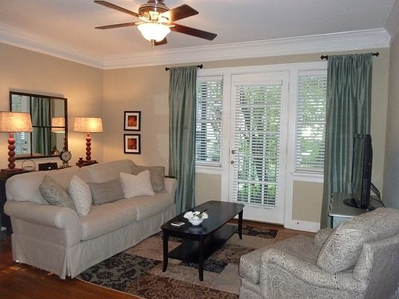 Lovely large living room with 15-light door with side lights to roomy terrace overlooking courtyard.
