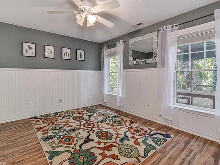 Other downstairs bedroom with windows overlooking the back patio and lots of greenery. Also has a very deep closet.