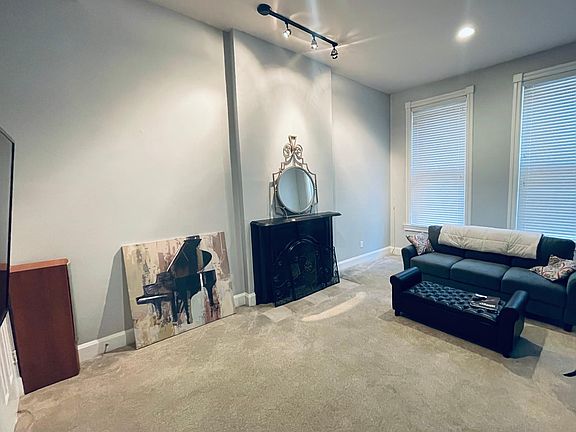 Great living room with with historic fireplace and large windows!