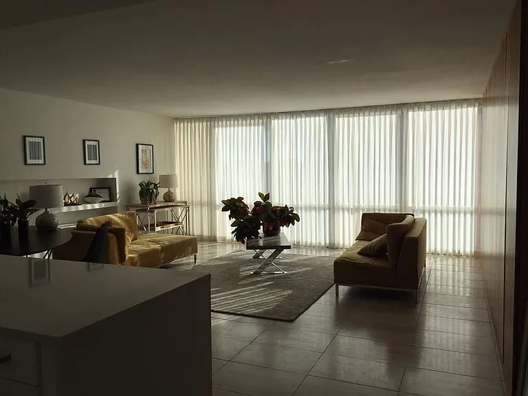 Large living room with travertine floors, beautiful wall of built-in closets, sleek appearance, floor to ceiling windows- fantastic light and Mountain Views