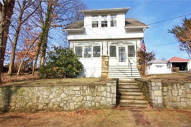 Welcome this this lovely colonial home with many original touches combines with updates of today.  Stone walls line the front of this home set on a hill.