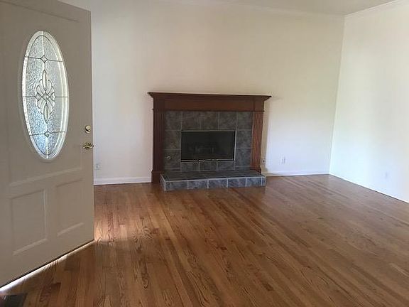 Living room with real hardwood floors, gas fireplace with mahogany mantel