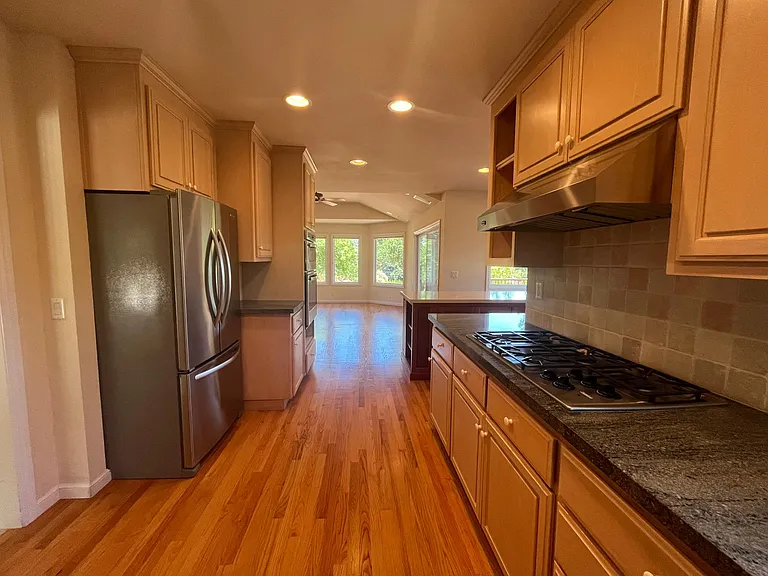 Wonderful gourmet kitchen is equipped with stainless steel appliances, quartz countertop, a lengthy island and soft-close cabinetry.