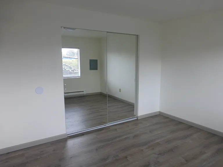 Spacious bedroom with new mirrored closet doors over the large closet space with shelf.