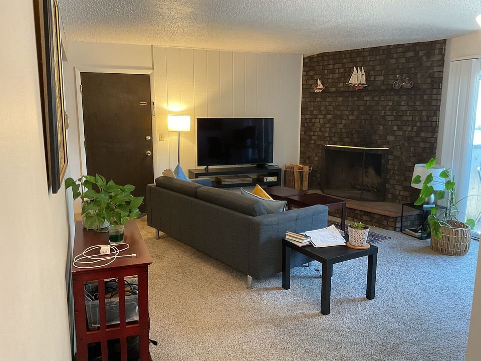 Living room with fireplace and patio