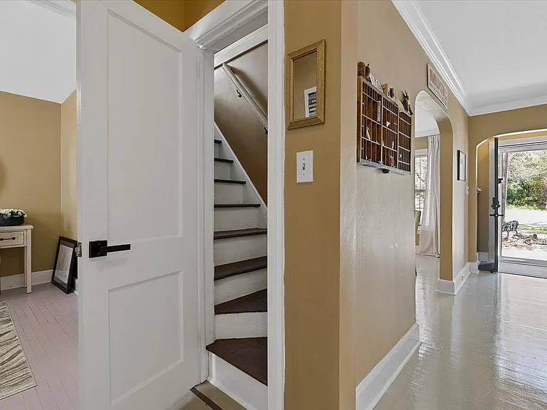 Steps leading to Landon's Room at Hunsucker's Place, a charming walk-up attic featuring two twin beds with memory foam mattresses and a Smart TV. Perfect for relaxation or entertainment, this cozy retreat is located within walking of Downtown Greensboro.
