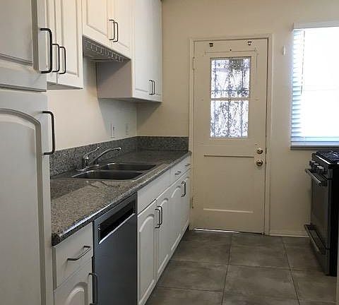 Kitchen with tile floor and new appliances
