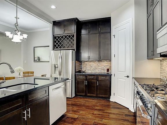Another view of the kitchen â large walk-in pantry and cabinets to the ceiling give lots of storage.