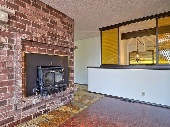 Main Floor Family Room with Old Seattle Brick from 1st & 2nd Aves, Wood Insert