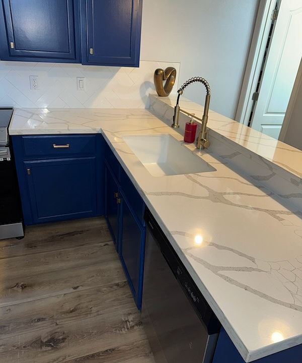 Kitchen updated with quartz countertops and stainless steel appliances.