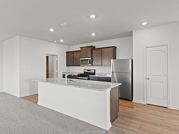 The kitchen has sprawling granite countertops.