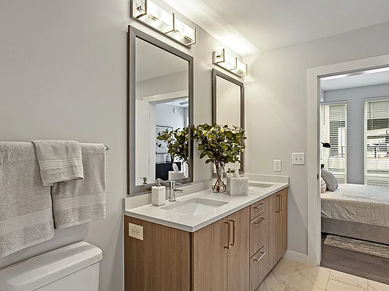 Polished Bathroom With Porcelain Tile Backsplash And Mocha Espresso Cabinets