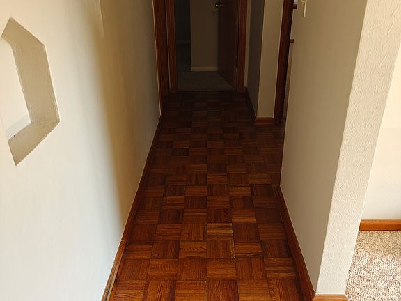 Hallway with wood parquet floors