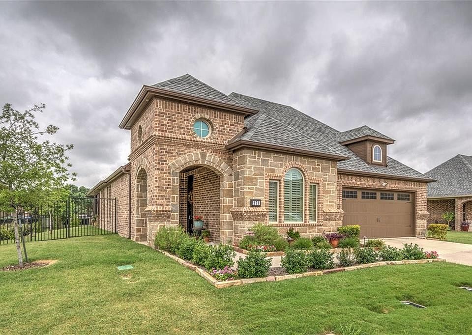 All brick exterior with over-sized garage in gated community. All exterior structure & landscape is fully insured and maintained by HOA.