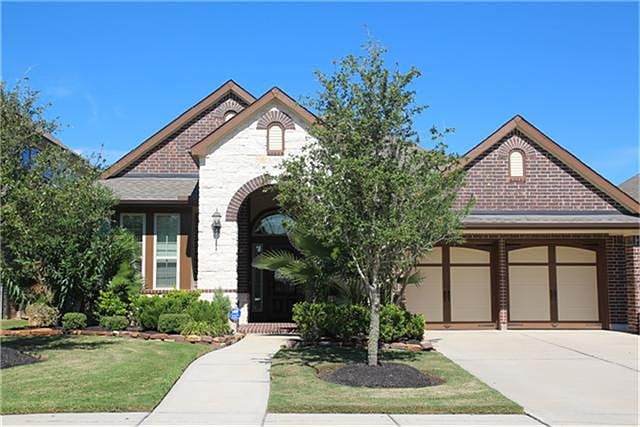 Inviting stone and brick elevation with a front porch.