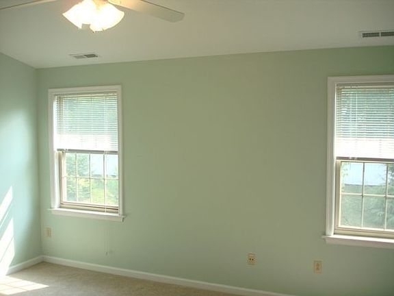 Well-Lit Master Bedroom with Cathedral Ceiling and Fan. Looks out to backyard