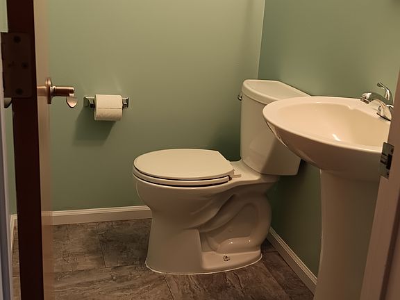 Half bath by living room and kitchen