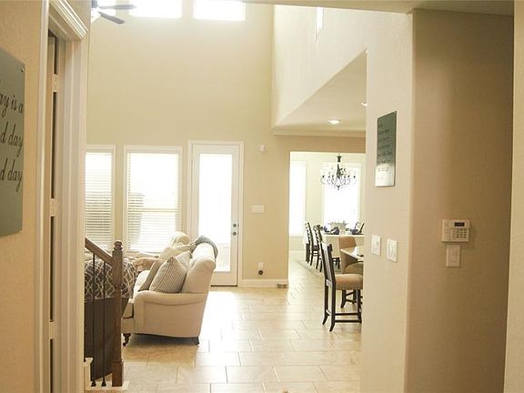 Looking into home from entryway. Lots of light and high ceilings. Open to kitchen on the right here.
