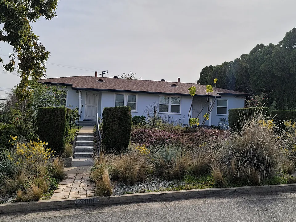 3100 Norwich is on the left side of duplex. Stairs lead to 3100 unit. It is a corner lot.