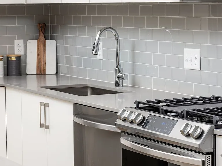 Grey tile backsplash and grey quartz countertops