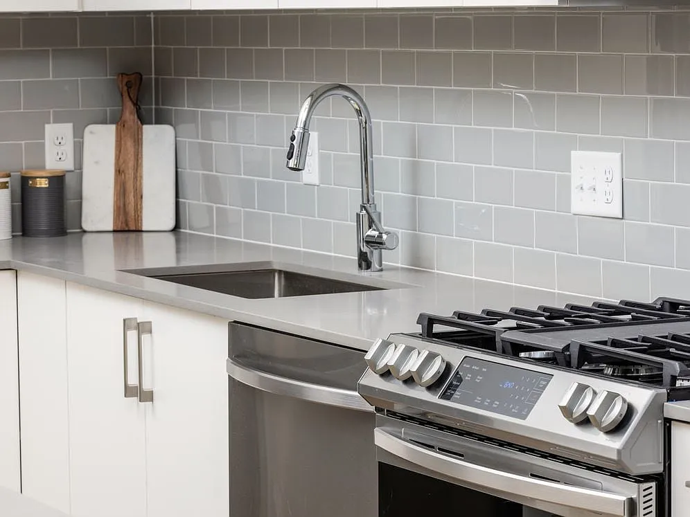 Grey tile backsplash and grey quartz countertops - Avalon North Andover
