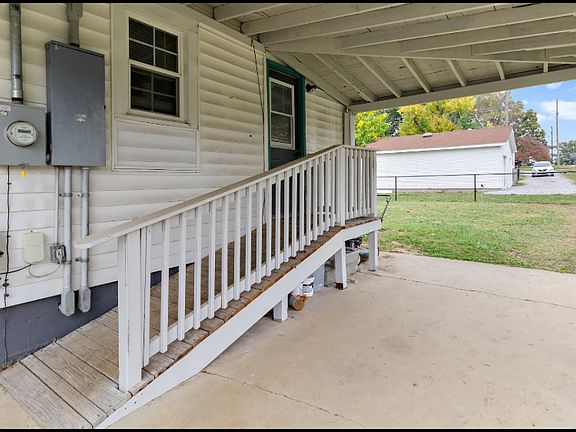 Covered patio with ramp access to utility room.