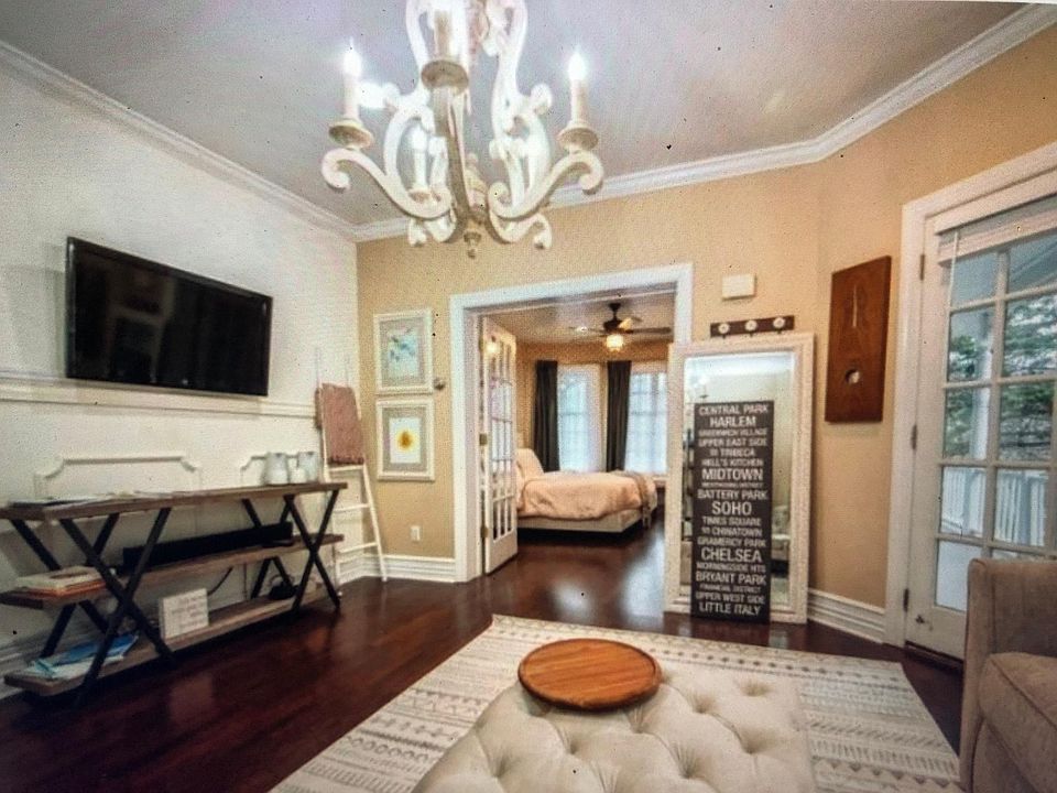 Living room. TVs included with view to the large bedroom with a King Sized Bed.