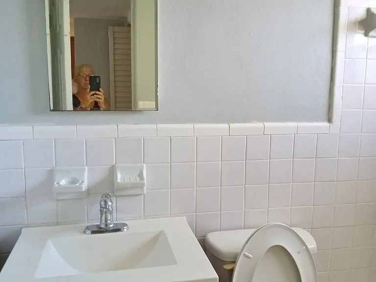 Medicine cabinet and tiled bathroom with full bath