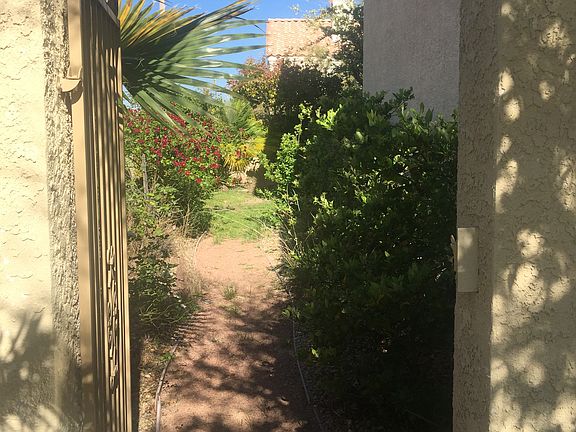 Side yard with pebble path