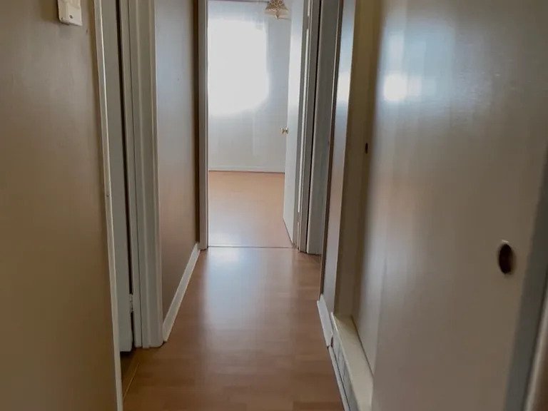 hallway with pantry/storage and coat closet
