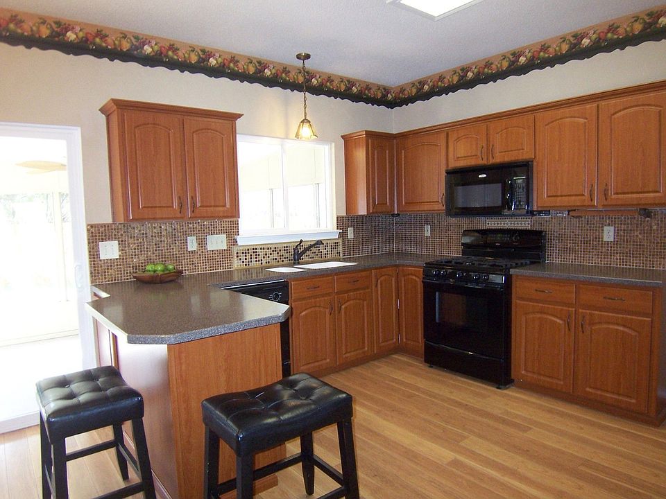 Kitchen-corian counters and glass backsplash