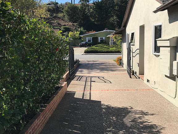 Driveway that leads to detached double garage.