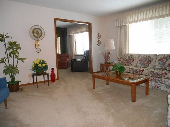 Large living room with great light opens to the den