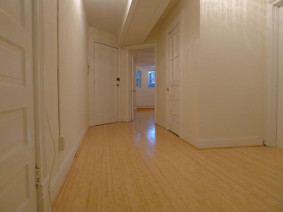 Hallway area with view into bedroom and apartment front door