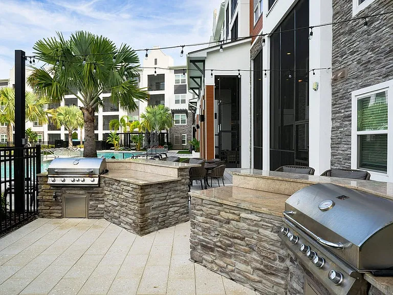 Elevate your lifestyle at The Edison Daytona Apartments. This stunning outdoor space features sleek grilling stations and a relaxing poolside atmosphere, perfect for gatherings or unwinding. Explore your new home today!