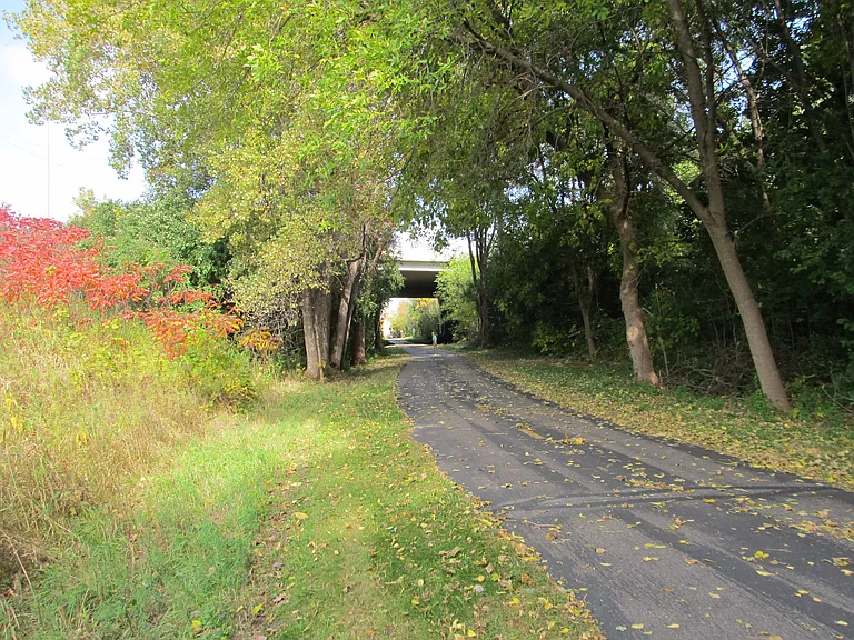 Black top trail borders property, easy walk to shopping