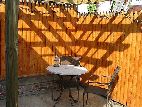 Fenced courtyard with pergola off kitchen