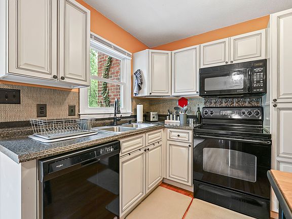 Appliances include dishwasher, stovetop and oven, microwave and refrigerator.
