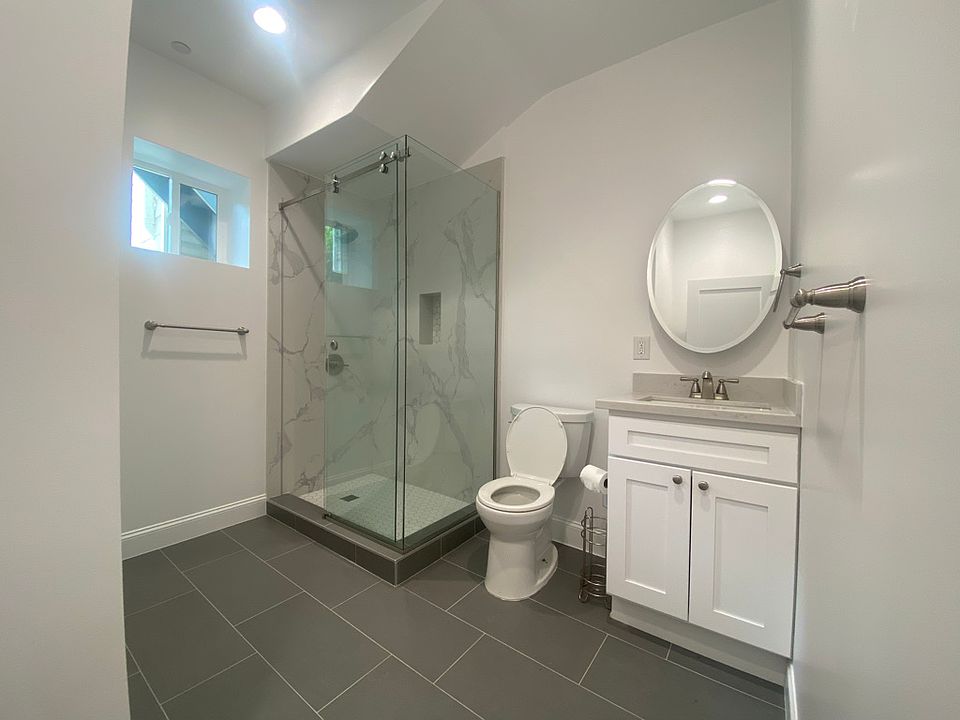 Spacious bath and shower with medicine cabinet behind the mirror