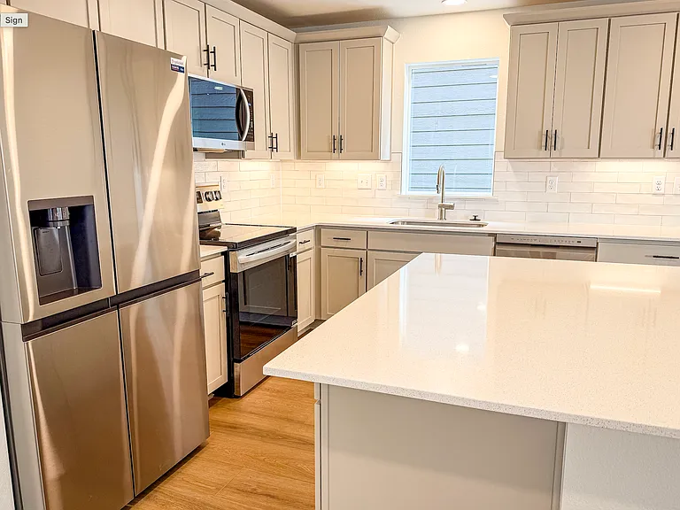 Modern kitchen with stainless steel appliances, large island, and plenty of cabinet space_your dream cooking space!