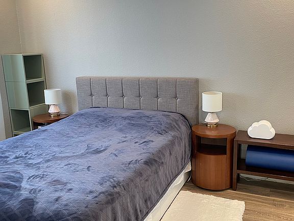 Queen size bed with headboard. 2 small nightstands.