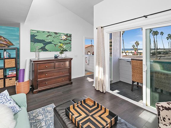 Facing towards entrance, view of living room and balcony