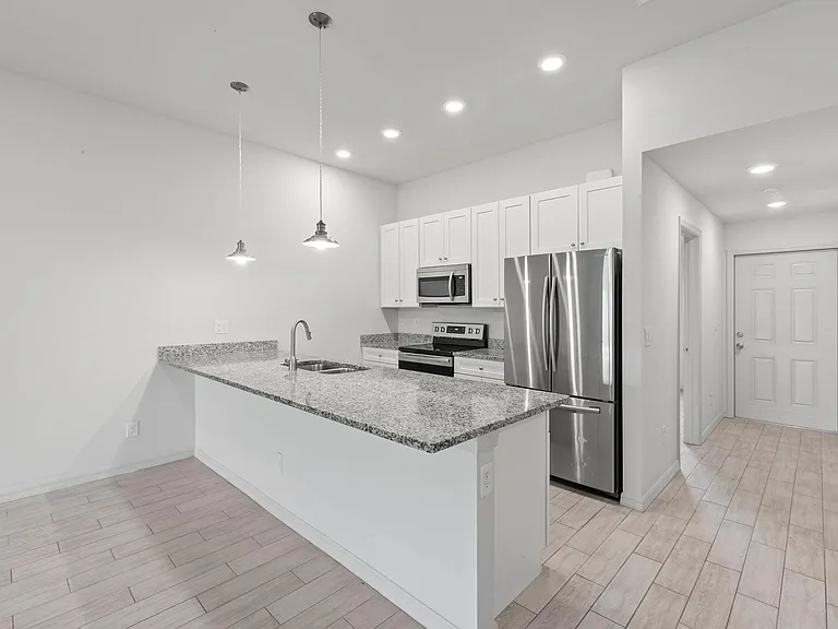 Chef's kitchen with gourmet 42" soft close wooden cabinets and drawers. All stainless steel appliances
